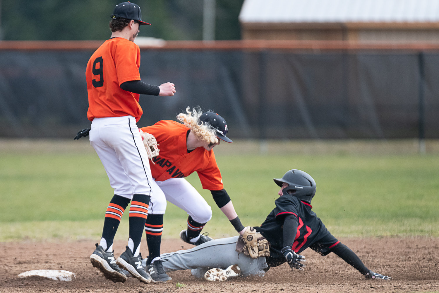 Napavine's Beckett Landrum puts a tag on Toledo's Hunter Feigenbaum during the Tigers' 4-1 loss to the Riverhawks in Game 1 of a doubleheader on March 20.