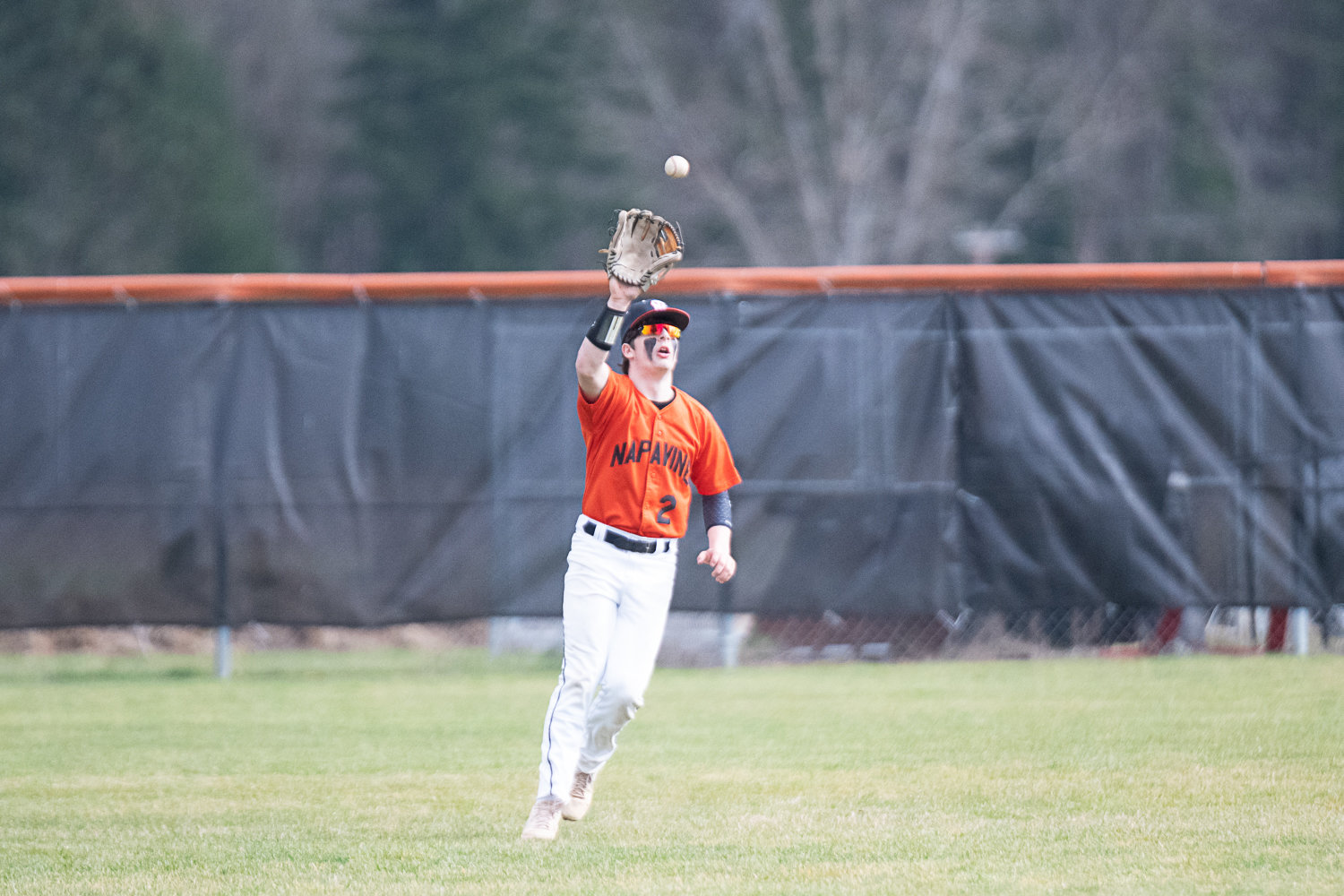 Austin Chapman gets under a ball during Napavine's 4-1 loss to Toledo on March 20.
