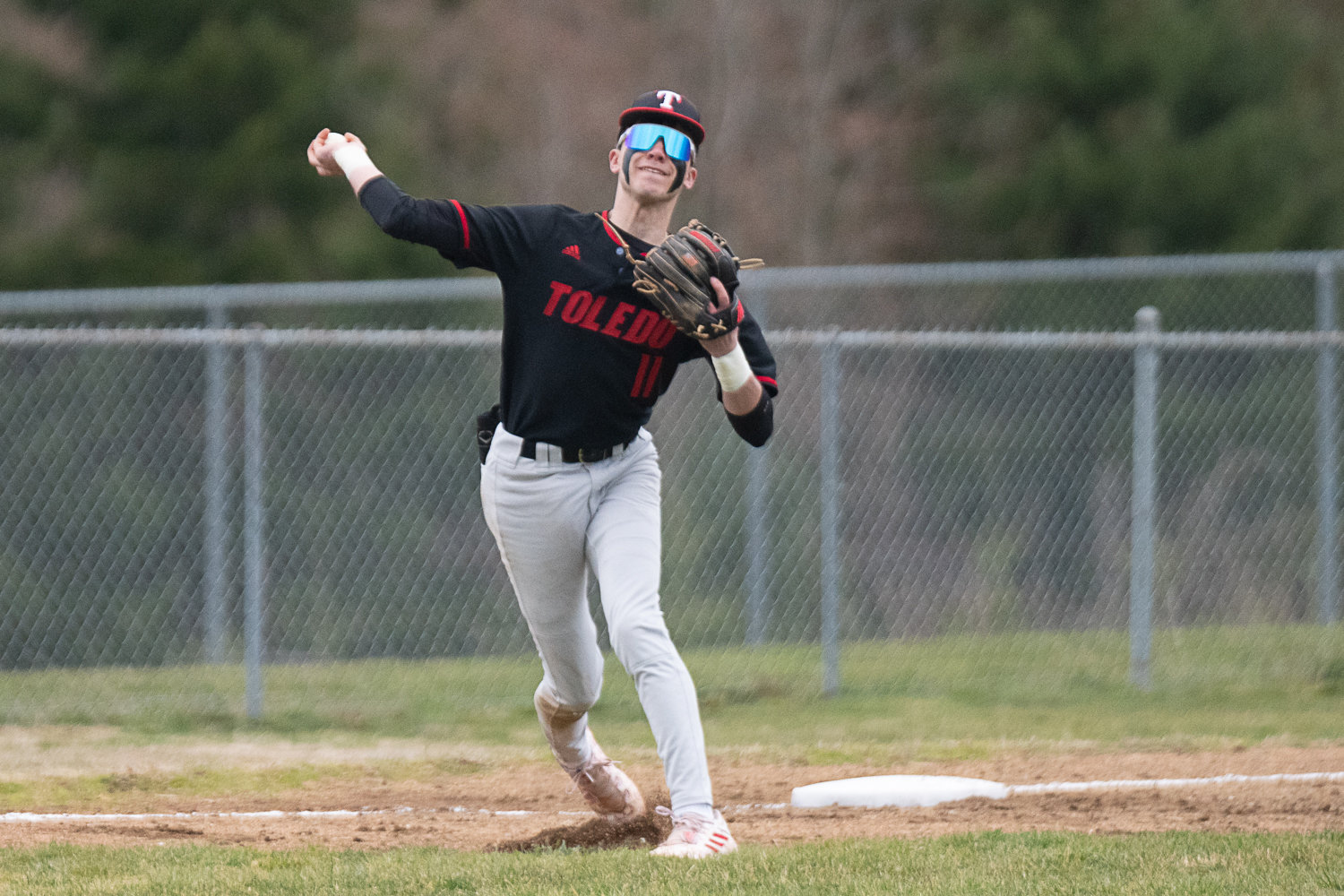 Toledo third baseman Carson Gould throws across the diamond during the first of the Riverhawks' two games against Napavine on March 20.
