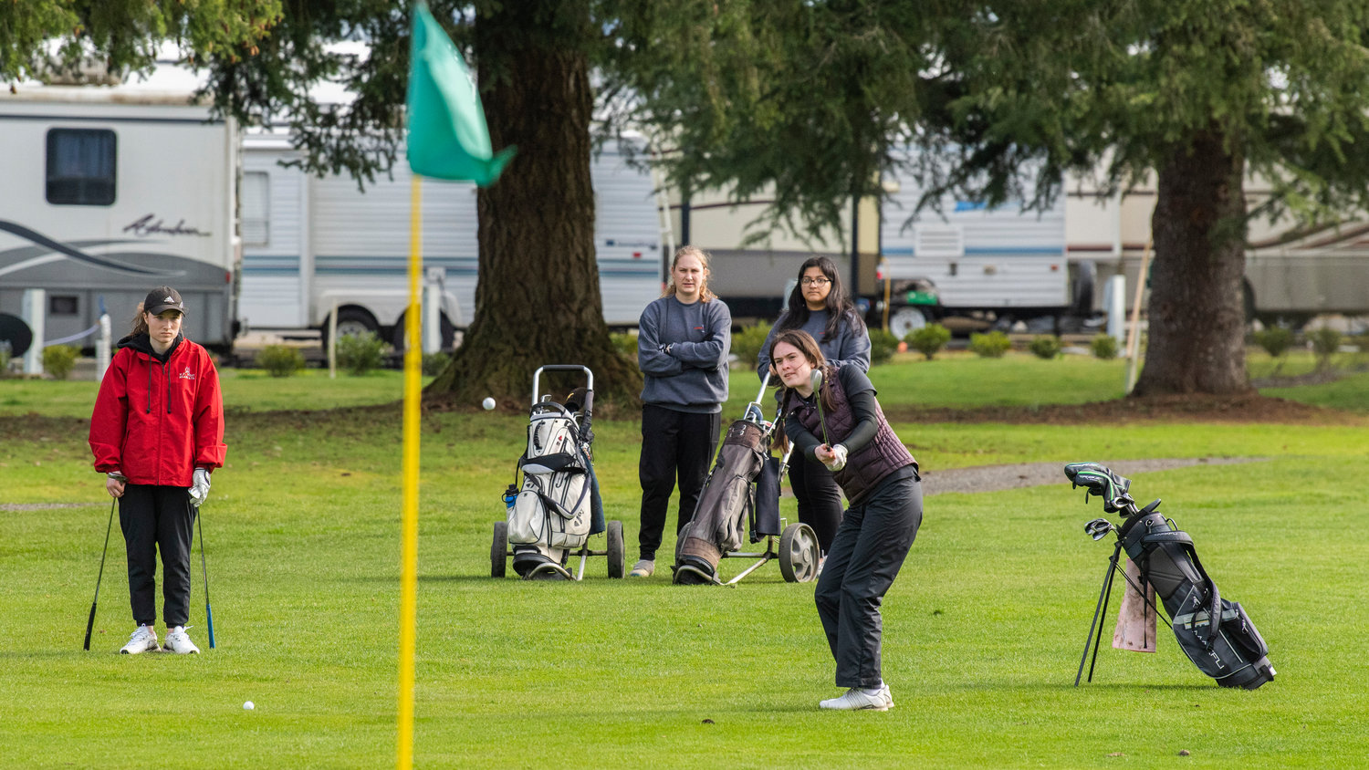 W.F. West junior Grace Oien hits a ball from the fairway at Riverside Golf Course Monday afternoon in Chehalis.