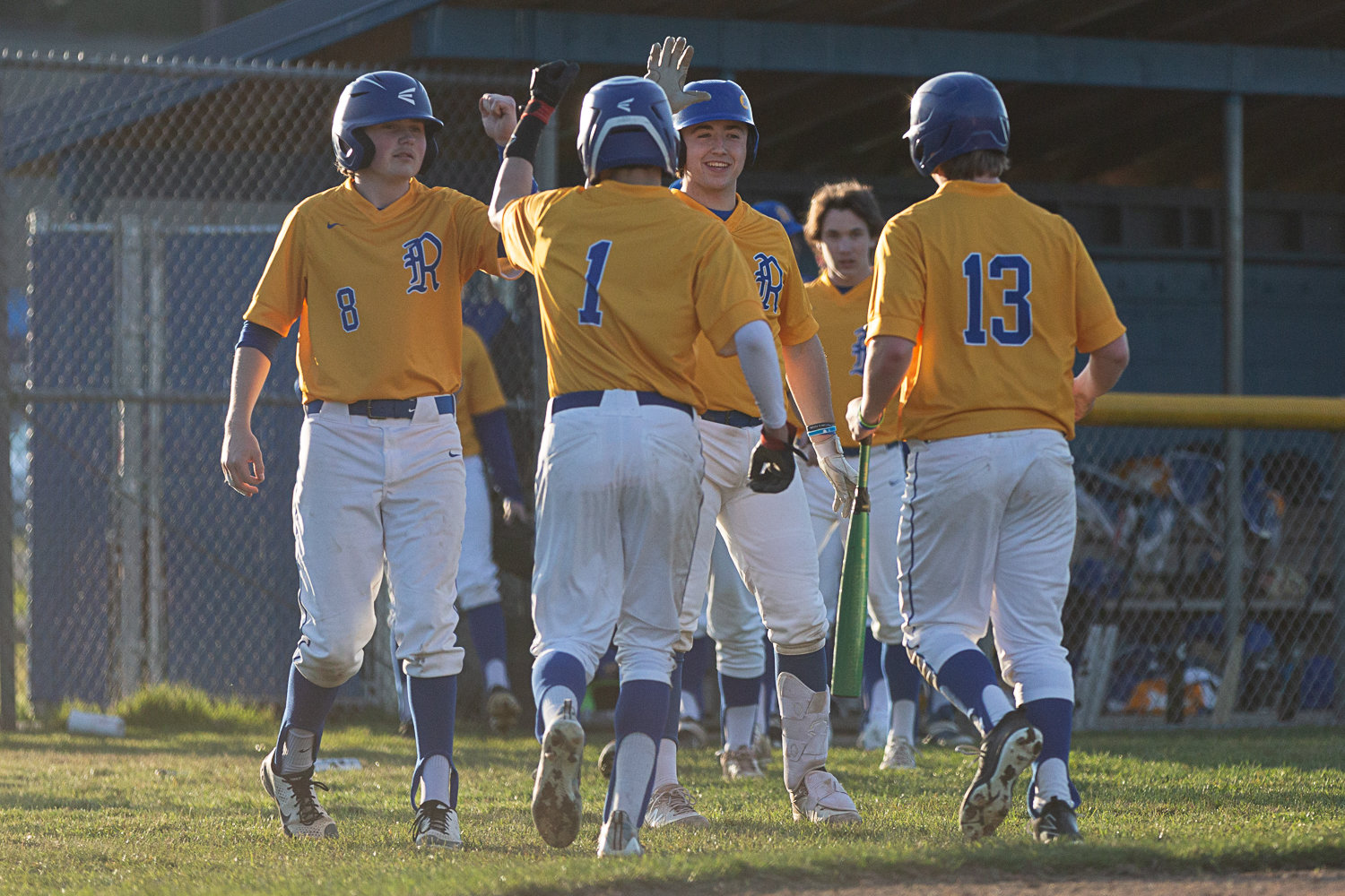 Rochester celebrates after a run against W.F. West at Heinz-Rotter Field March 21.