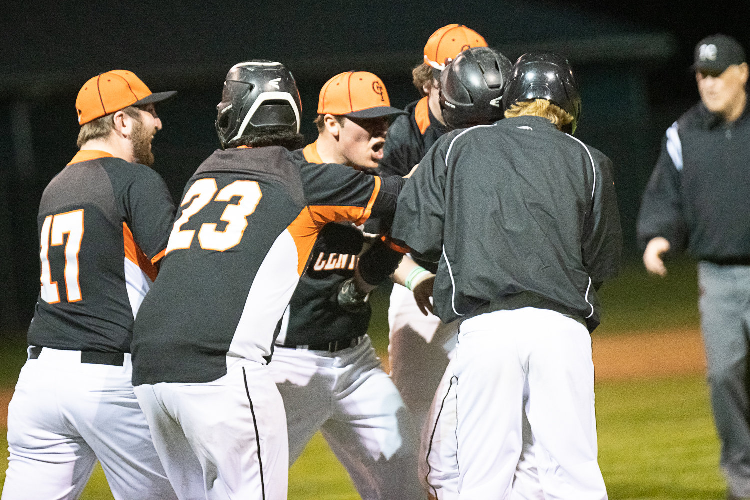 Centralia players mob Moshie Eports-Tartios after his walk-off sacrifice fly gave the Tigers a 14-13 win over Aberdeen on March 21.