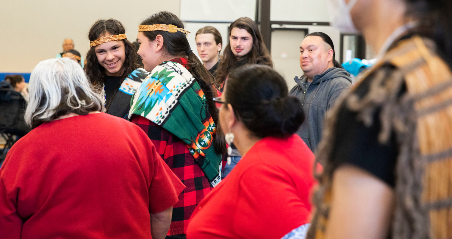 “William,” or Agugaluk Komakhuk, smiles to Yvonne Peterson alongside his brother “Junior” or Aholagana Komakhuk after being welcomed into the Hazel Pete family at the Chehalis Tribe Community Center in Oakville on Saturday.