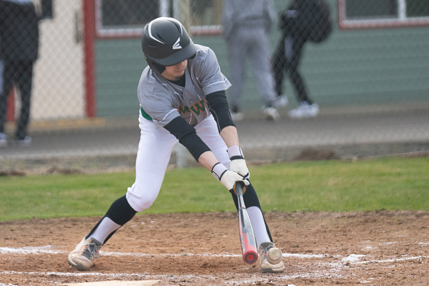 Brecken Pelletier goes down to his shoetops to reach a pitch during MWP's first game at Winlock on March 27.