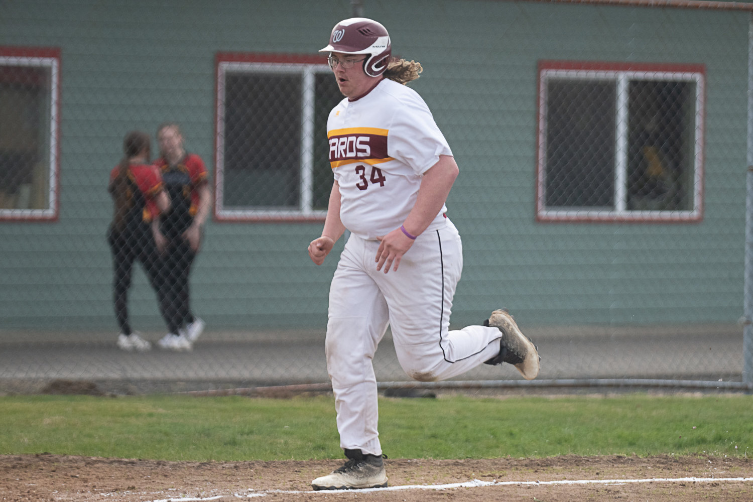 Christian Uhri runs home to score during Winlock's first game of the day against MWP on March 27.