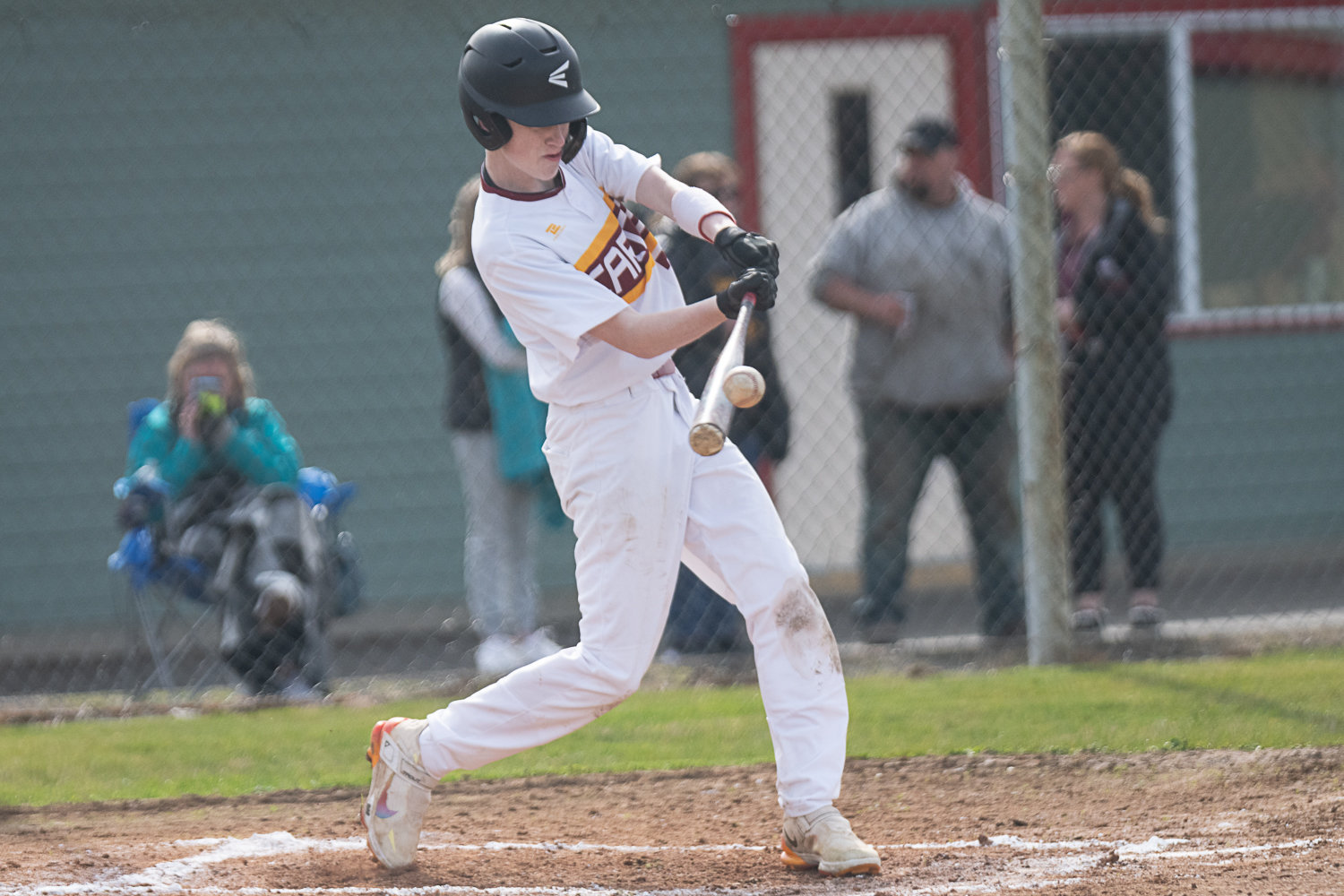Carter Svenson makes contact during Winlock's game against MWP on March 27.