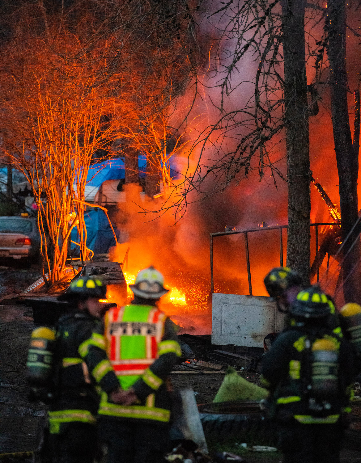 Riverside Fire Authority, Centralia Police and Chehalis Fire respond to a scene at the end of Eckerson Road in Centralia as a propane tank shoots flames from a structure inside a homeless encampment Tuesday, March 28, 2023.