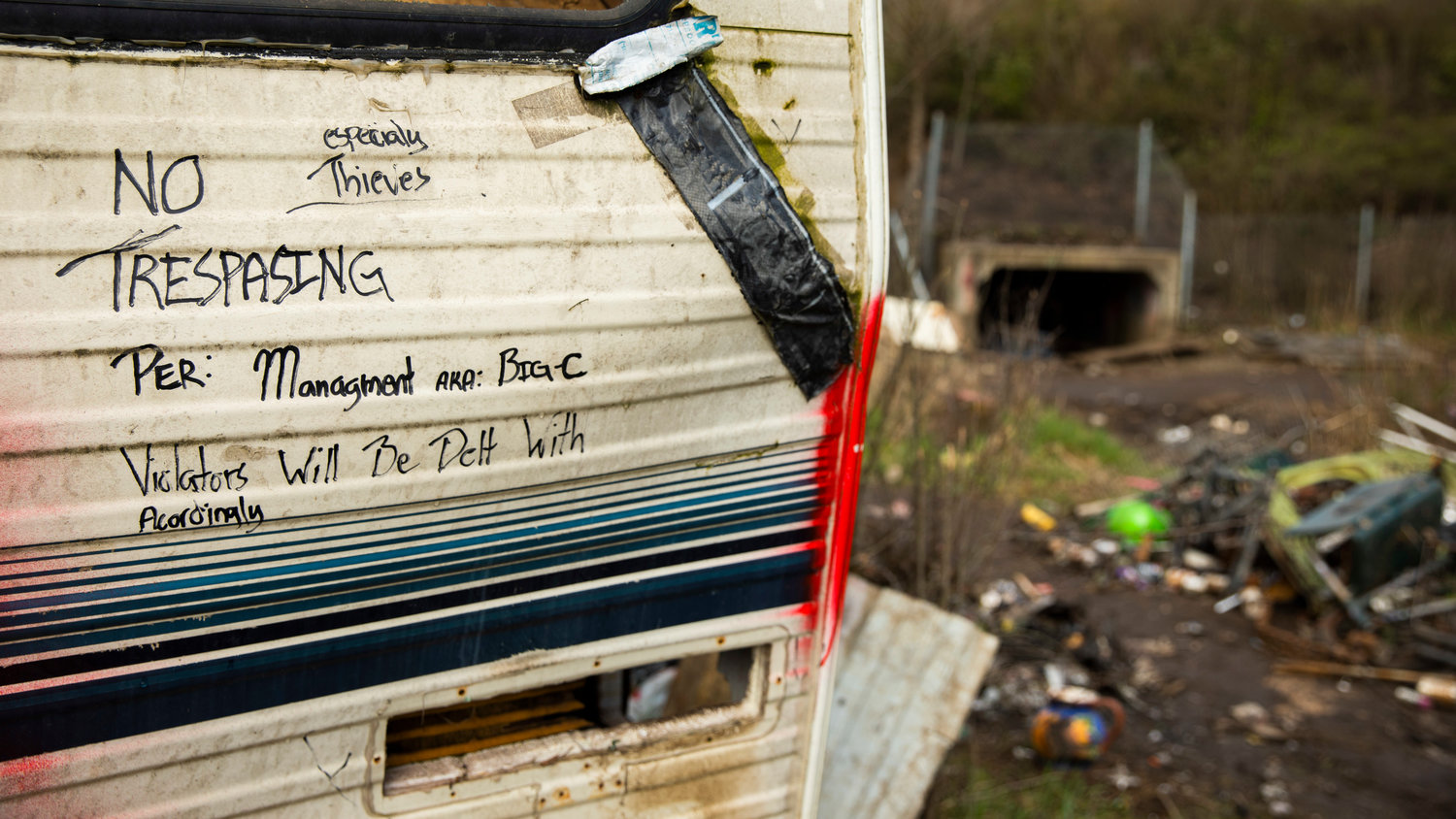 A message is seen written on a trailer at a homeless encampment near Blakeslee Junction on Wednesday, March 29, 2023.