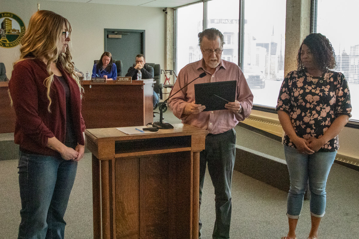 Chehalis Mayor Tony Ketchum, center, reads a proclamation declaring April to be Child Abuse Awareness Month during Monday night's city council meeting with Jasmine Trent, right, and Kassie Jadin, left, from Family Education and Support Services.