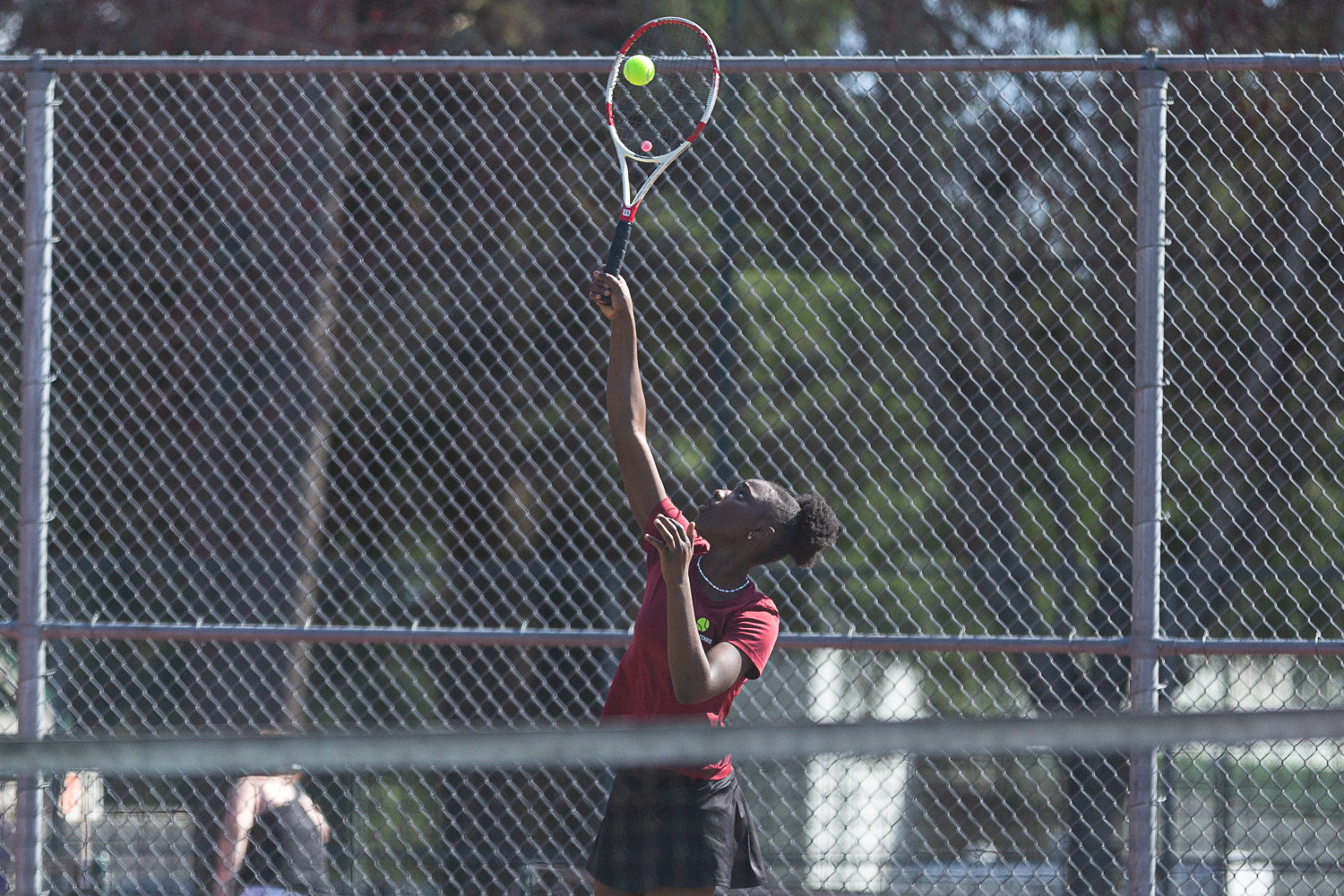 W.F. West singles player Mari Ceesay serves against Tumwater March 29.
