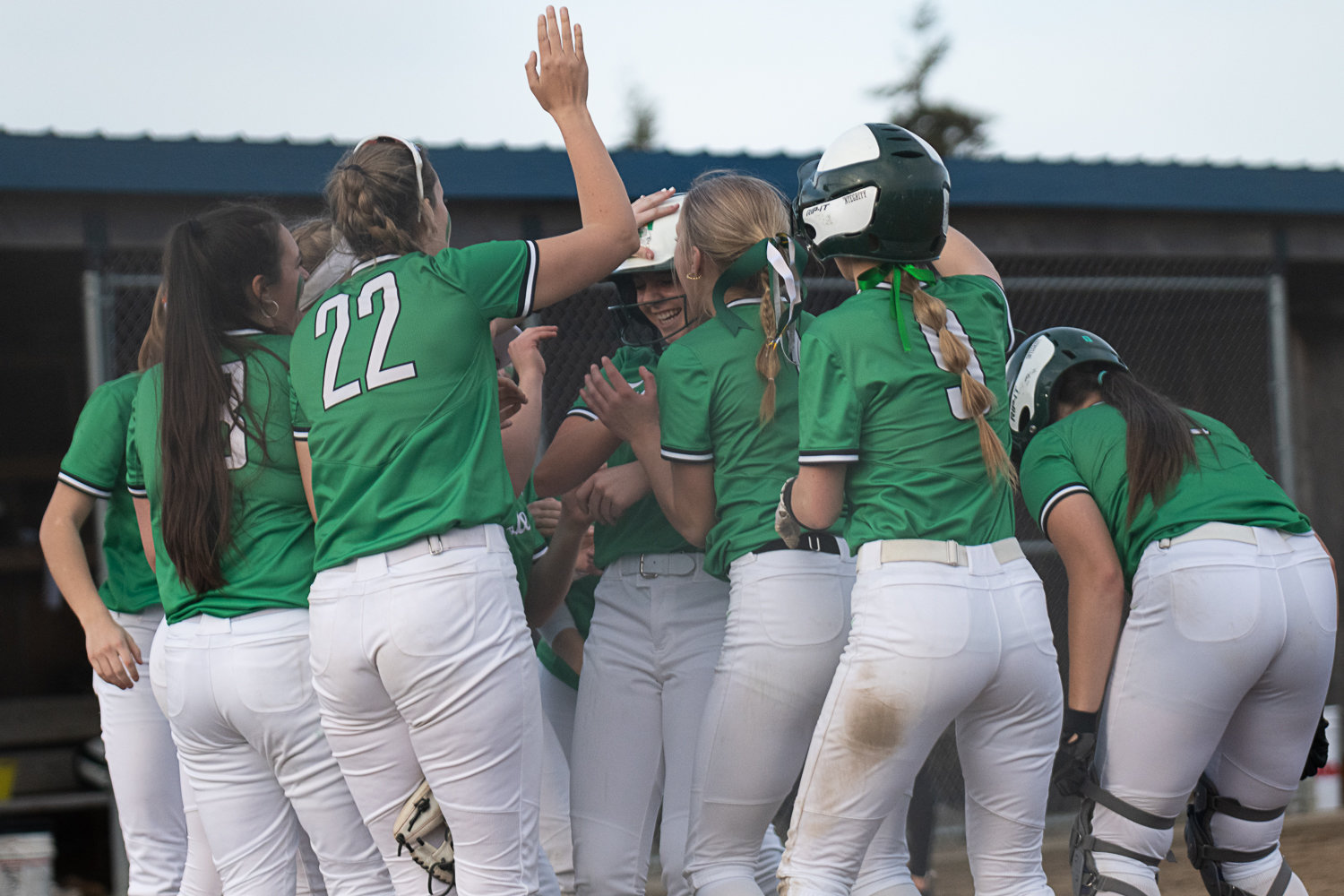 Kylie Waltermeyer's teammates welcome her at home plate after her two-run bomb in the seventh inning of Tumwater's 5-3 win over Rochester on March 29.