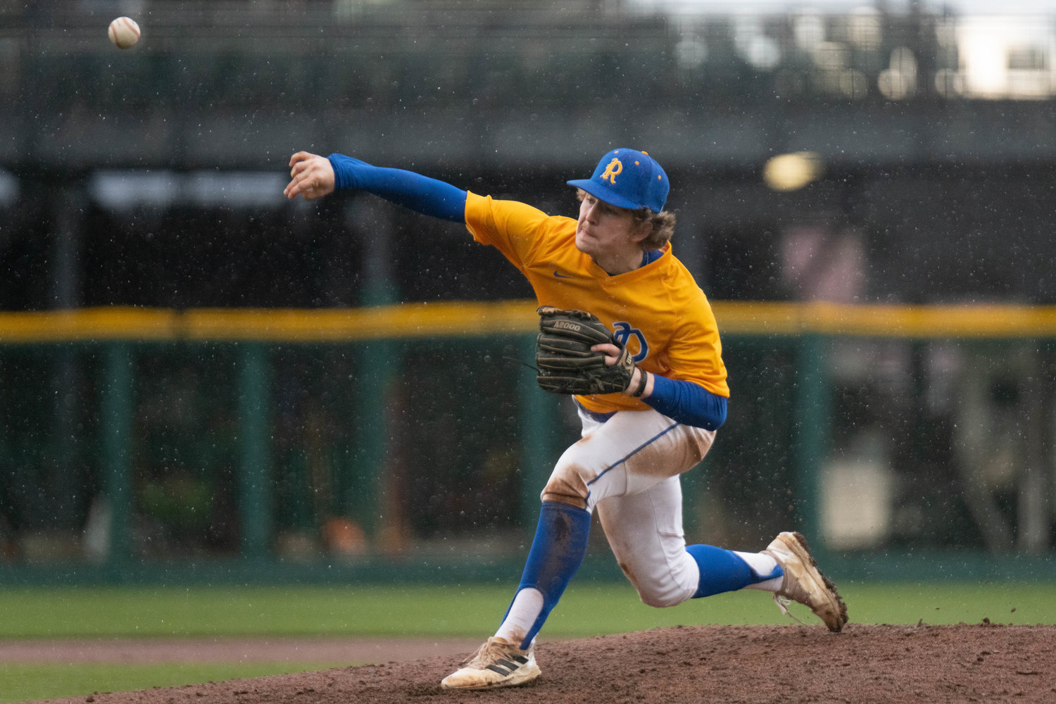 Braden Hartley throws a pitch throw the downpour during Rochester's 11-7 win over Tenino on April 1 at Cheney Stadium in Tacoma.