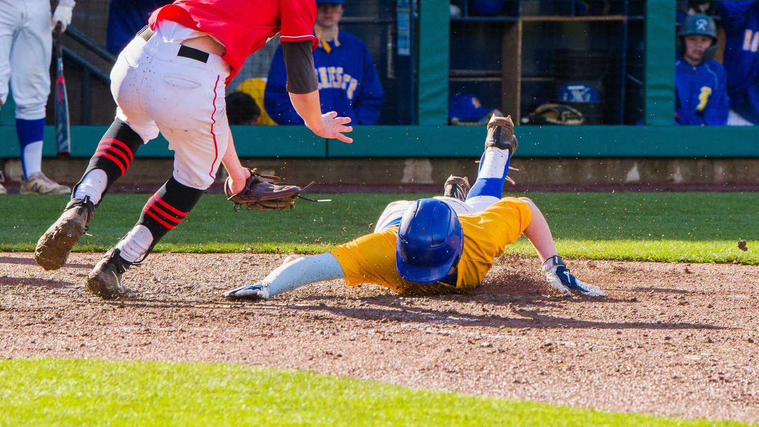 Rochester’s Henry Gramespacher (13) slides in safe at home during a game against Tenino at Cheney Stadium, home of the Tacoma Rainiers, Saturday afternoon.