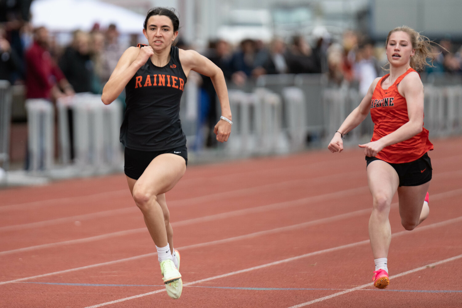 Rainier's Acacia Murphy and Napavine's Morgan Hamilton come down the stretch in the girls 100-meter dash at the Chehalis Activator on April 22.