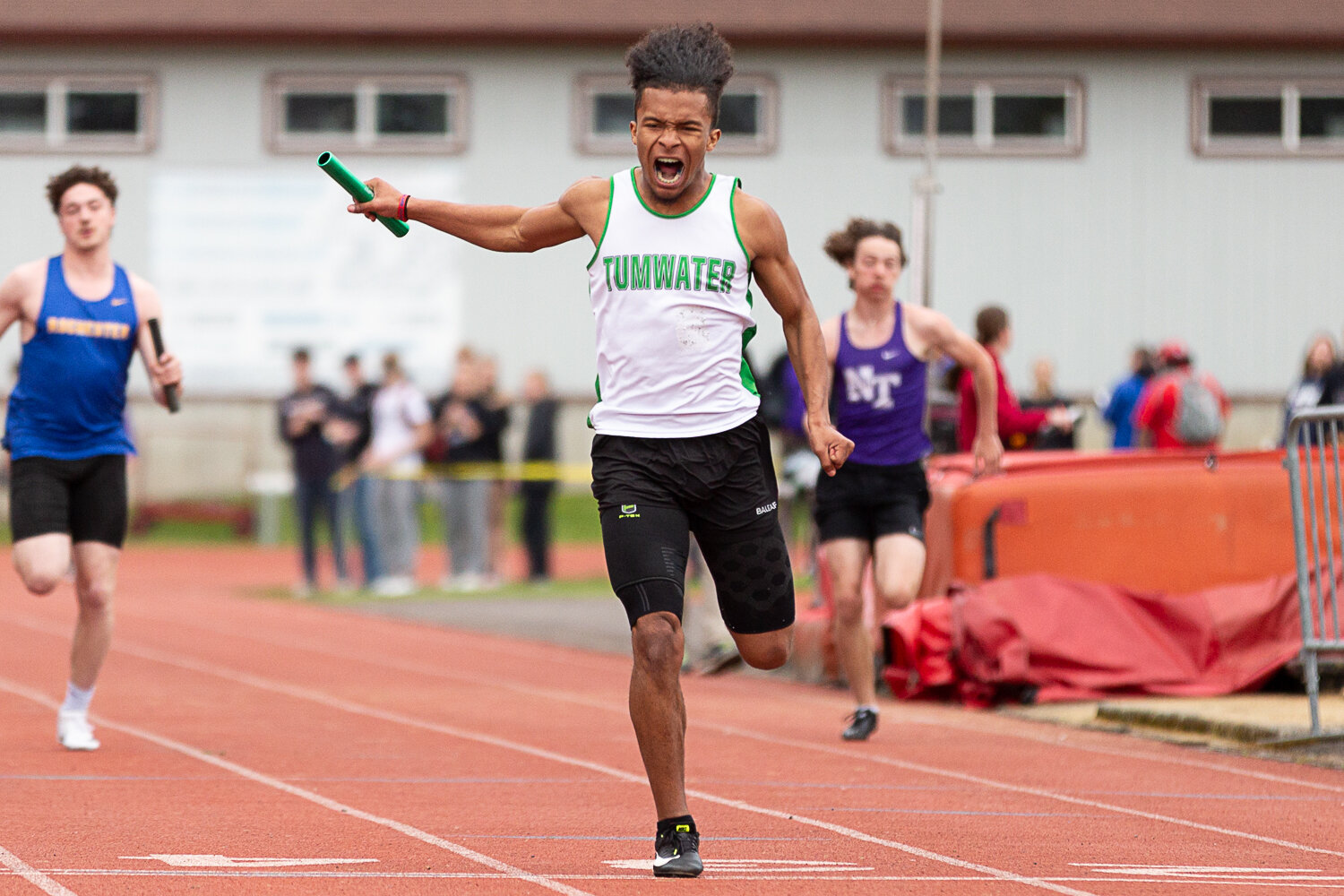 Tumwater's Jaxon Budd yells as he crosses the finish line in the 4x100-meter relay at the Chehalis Activators Classic April 22 at W.F. West.