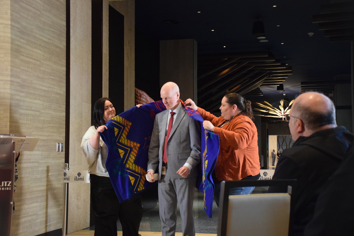 Mohegan Sun Director of Program Management Paul Tresnan receives a blanket from Cowlitz Indian Tribe members ahead of a ribbon cutting for the 14-story hotel at ilani April 24.