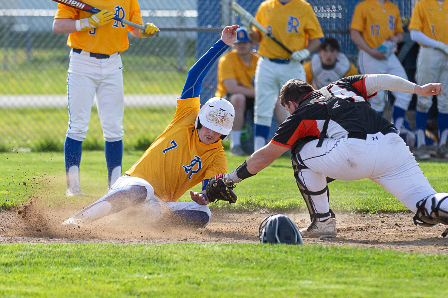 Rochester's Braden Hartley avoids the tag and slides home against Centralia April 26.
