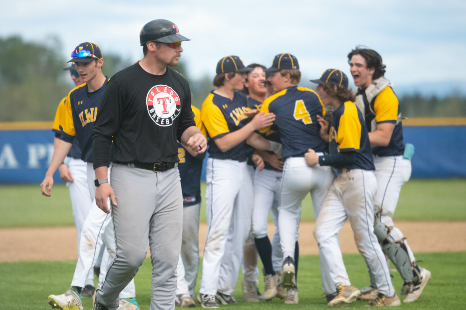 Toledo coach Mack Gaul walks past Ilwaco's celebration after the final out of the Fishermen's 5-4 win over the Riverhawks on May 9 at Adna in the 2B district semifinals.