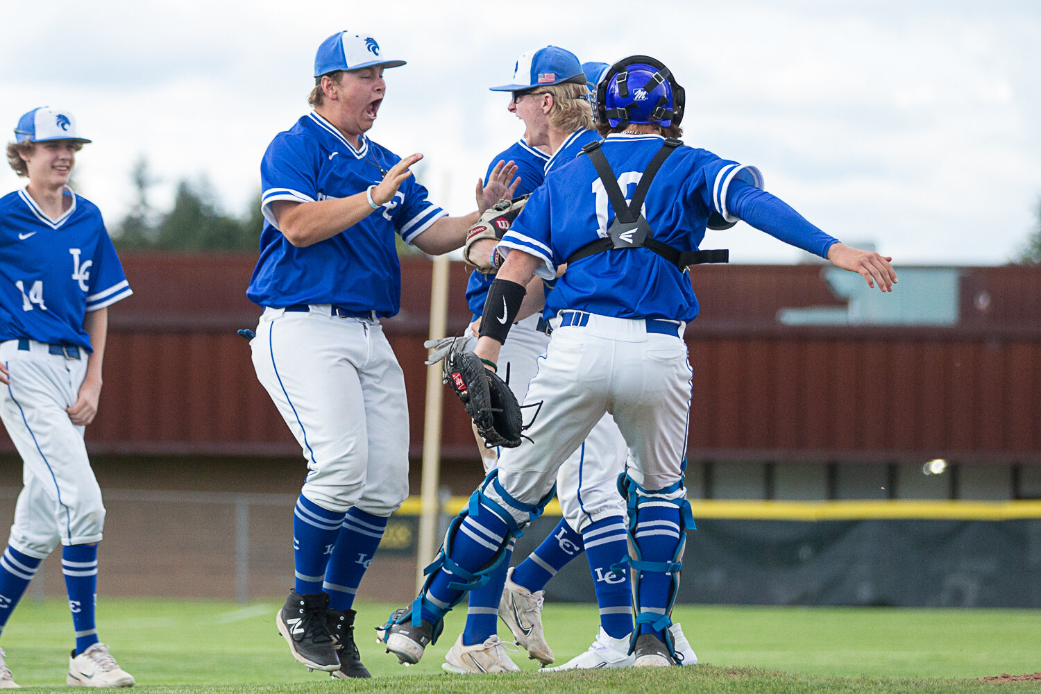 The La Center baseball team rushes to celebrate on the mound after a 5-4 win over Tenino in the 1A District 4 semifinals at Castle Rock May 9.