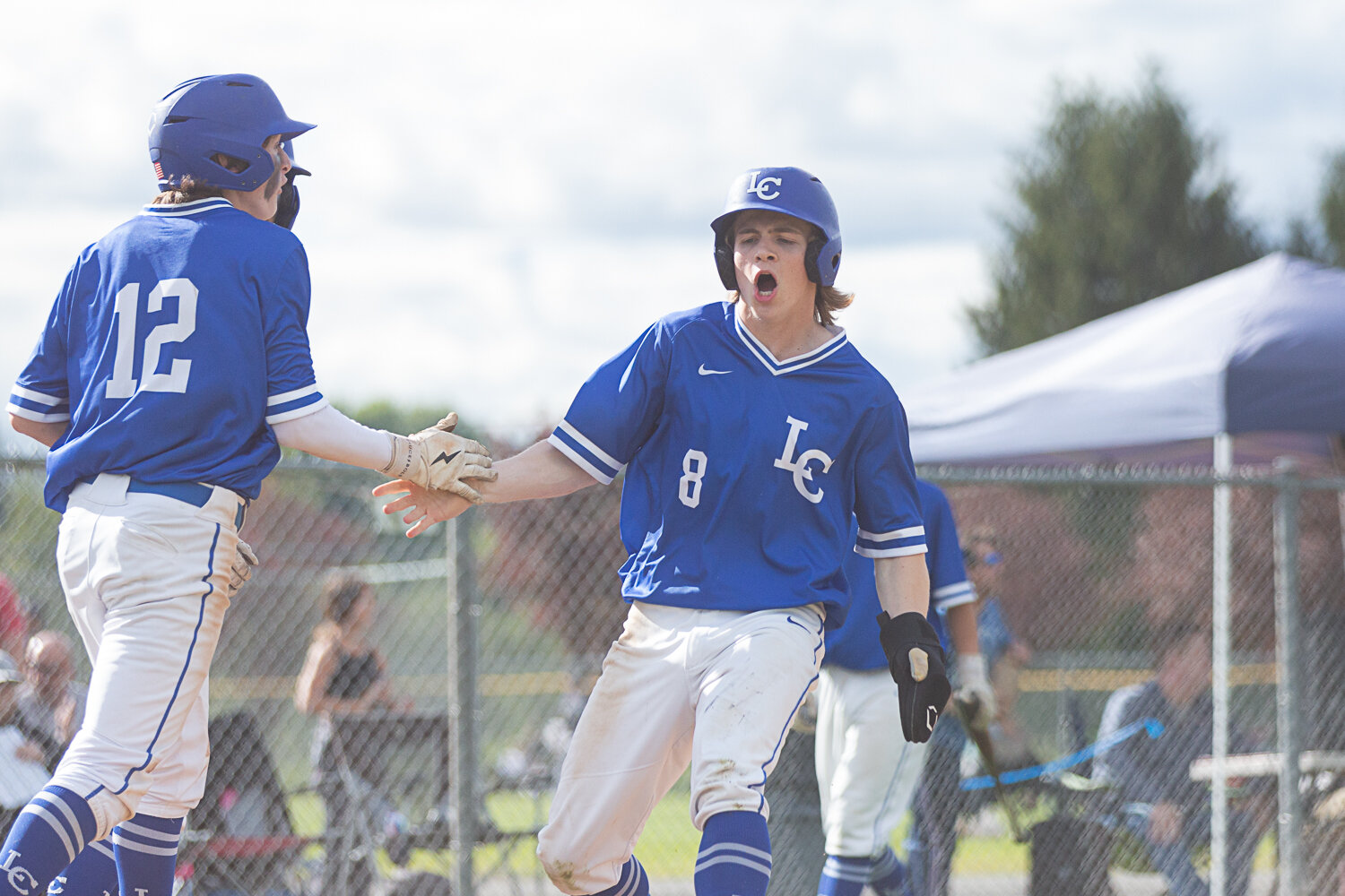 La Center outfielder Justin Fuller celebrates a three runs scored against Tenino in the 1A District 4 semifinals May 9 at Castle Rock.