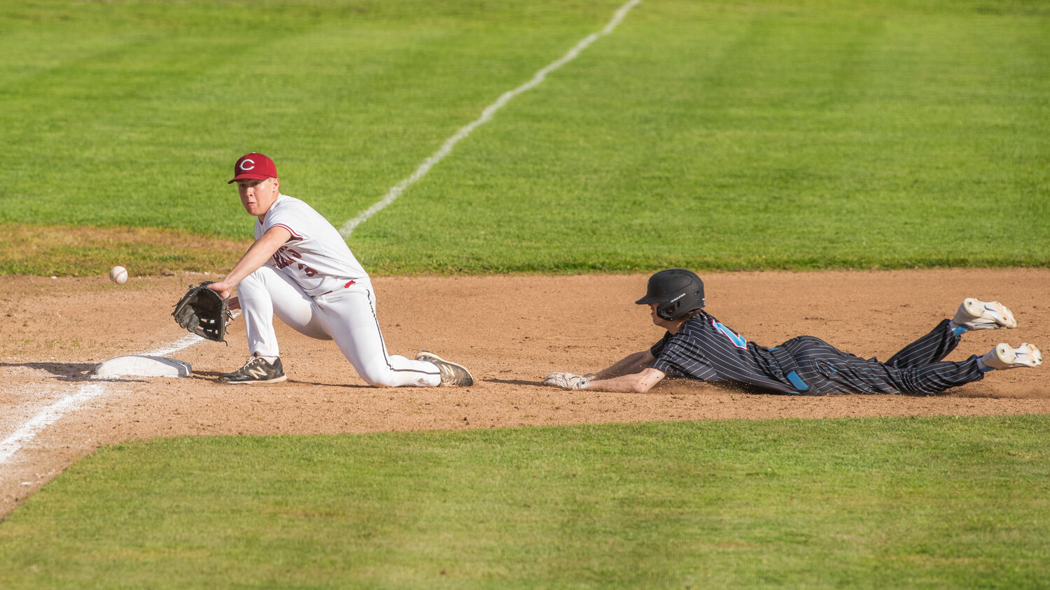 W.F. West’s Evan Stajduhar (3) receives a throw down to third base during a game against Mark Morris at Bearcat Stadium in Chehalis on Tuesday, May 9.