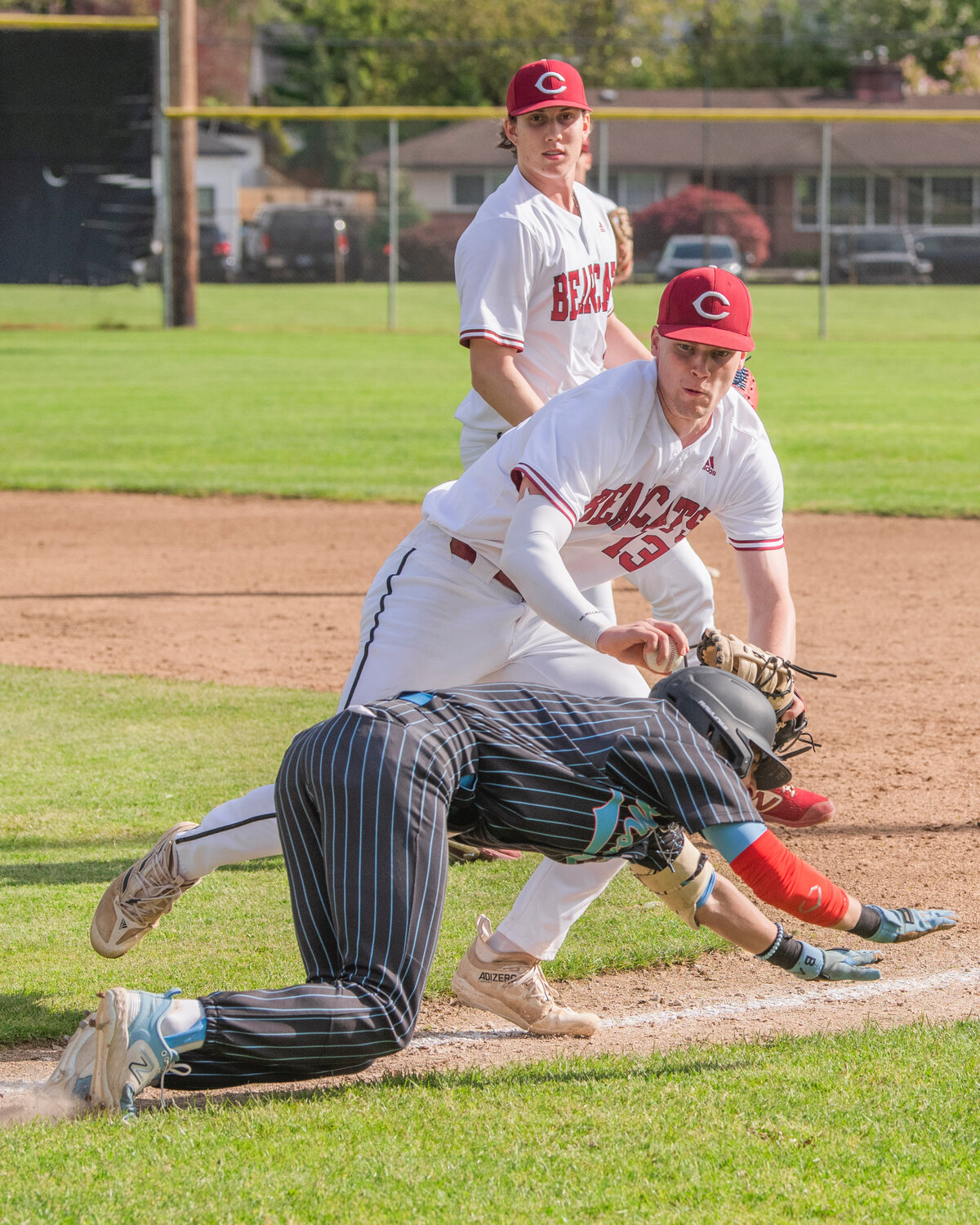 W.F. West’s Gavin Fugate (13) stops a runner on his way to first making an out during a game against Mark Morris at Bearcat Stadium in Chehalis on Tuesday, May 9.