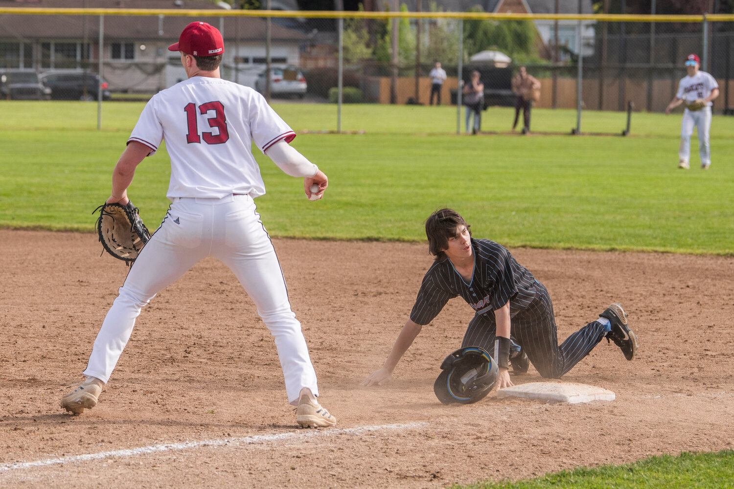 W.F. West’s Gavin Fugate (13) makes an out on a throw down to first base during a game against Mark Morris at Bearcat Stadium in Chehalis on Tuesday, May 9.