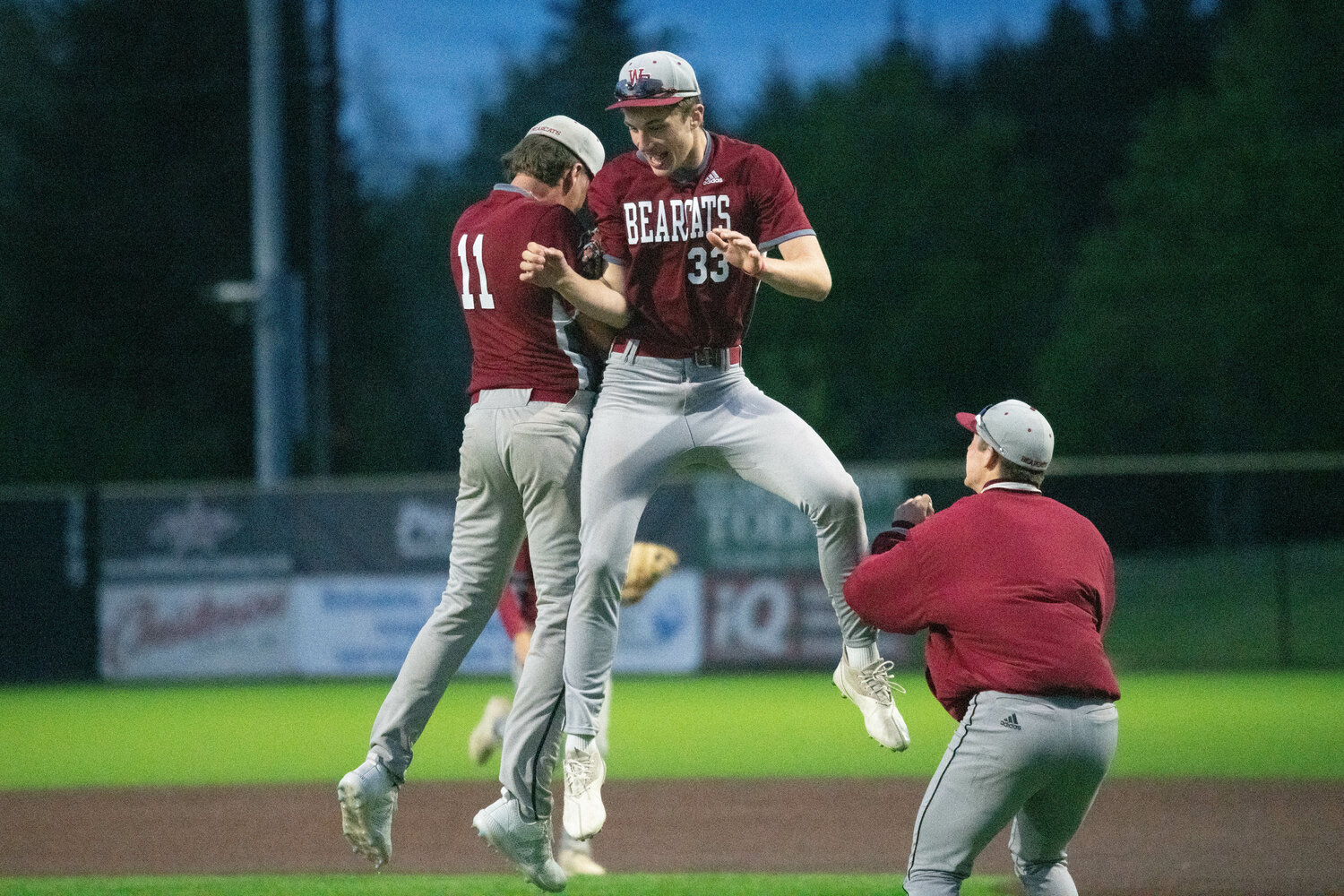 Riggs Westlund (11) and Grady Westlund (33) celebrate after the final out of W.F. West's 9-0 win over Ridgefield in the 2A District 4 Tournament semifinals, May 10 at the RORC.