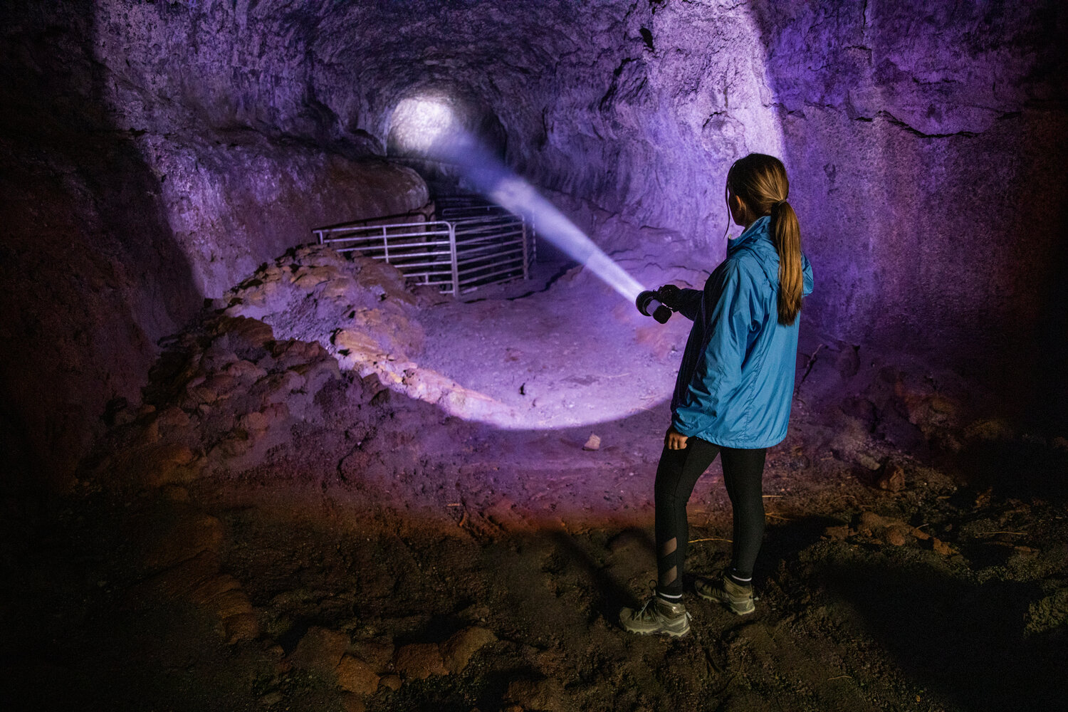Assistant Editor Isabel Vander Stoep uses a flashlight to light the way while hiking through the Ape Cave in Cougar on opening day Thursday, May 18.
