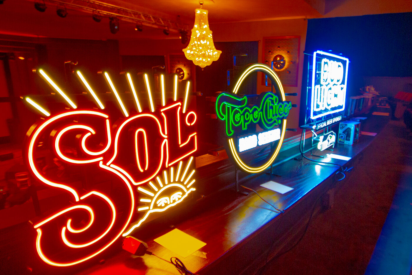 Neon signs were among the many silent auction items up for bid Saturday night at the Justin Ames benefit held to raise money for Ames' daughters after his death last month.