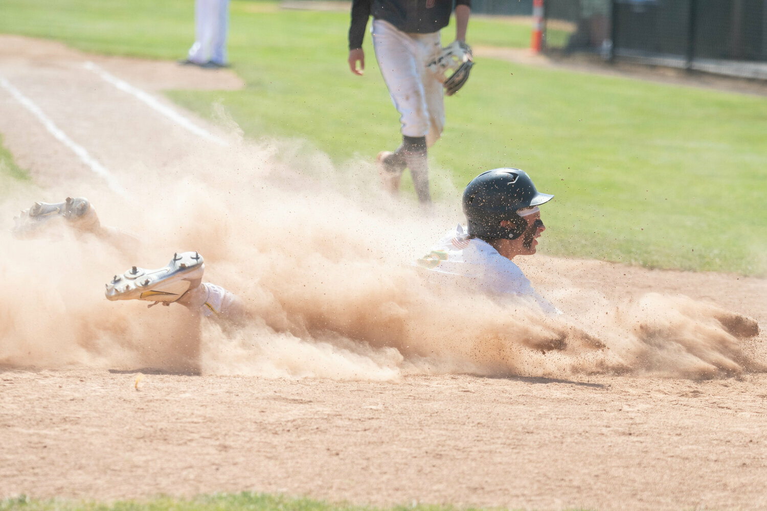 Eddie Marson dives home to score a run during Tumwater's 8-2 win over Grandview in the first round of the 2A state tournament, May 20 at Wheeler Field in Centralia.