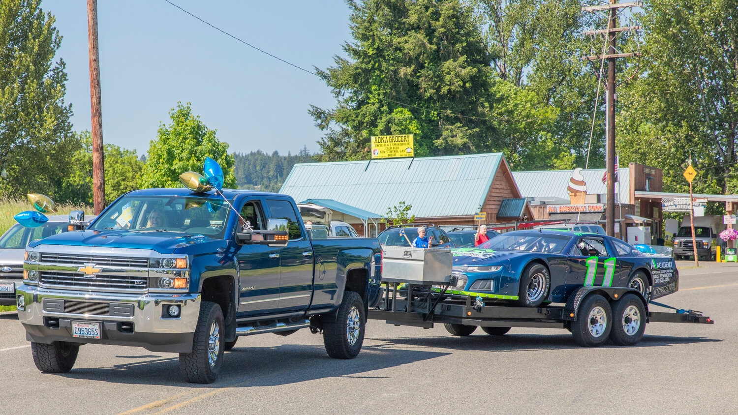 A truck and race car from the Academy Mortgage Corporation leads the Adna High School baseball team during a sendoff ceremony before state on Thursday, May 25.