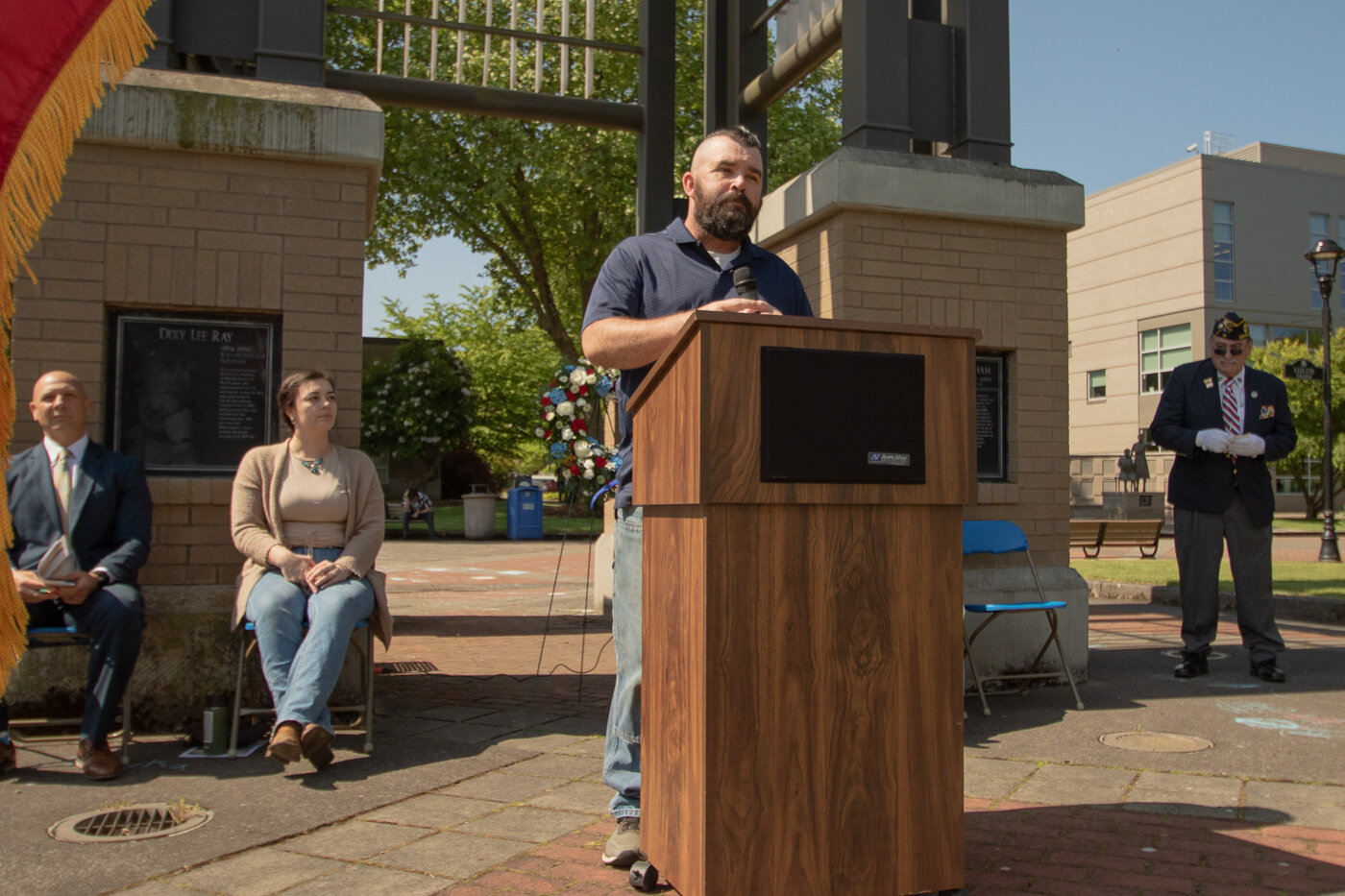 Centralia College student and campus Vet Corps navigator Paul Murphy talks at the college's Memorial Day ceremony Thursday morning by the campus clock tower.