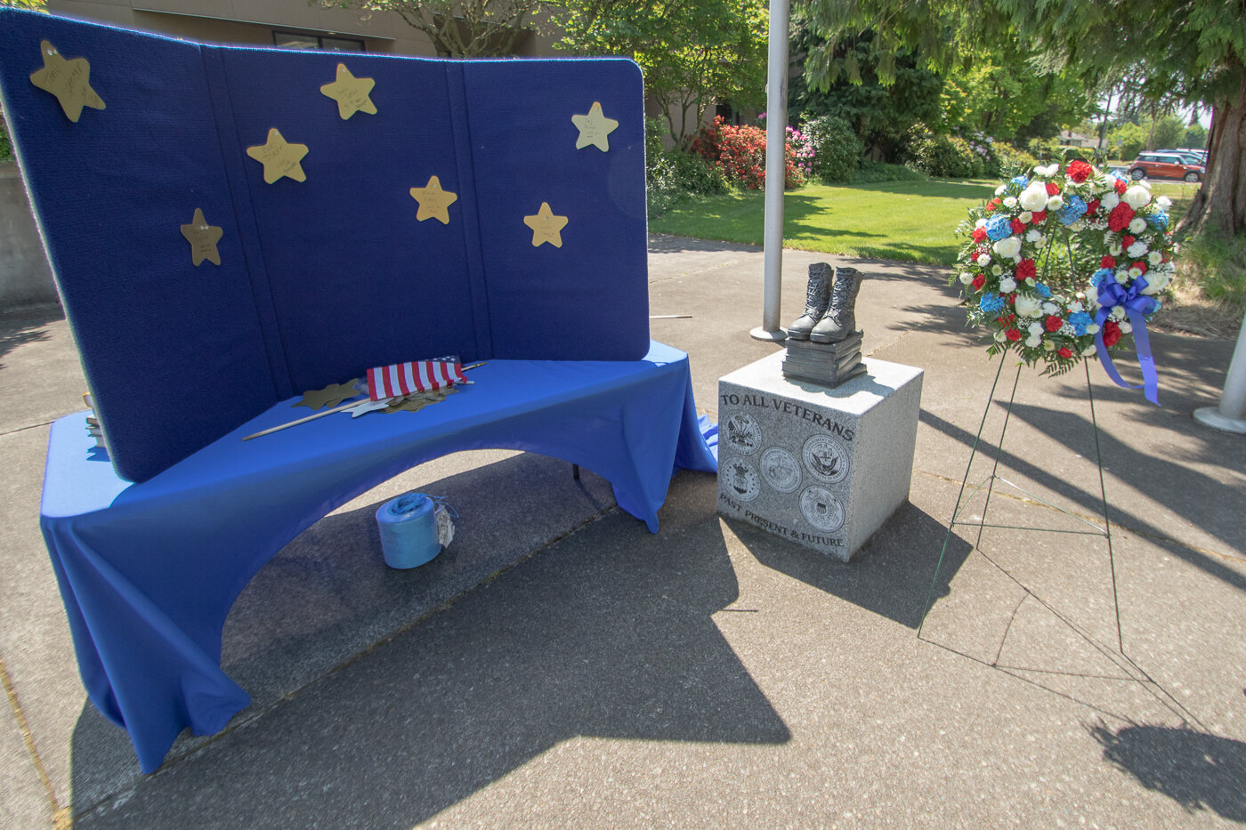 A display for attendees to write the names of fallen service members is seen next to Centralia College's Boots-2-Books statue on Thursday for the school's Memorial Day ceremony.