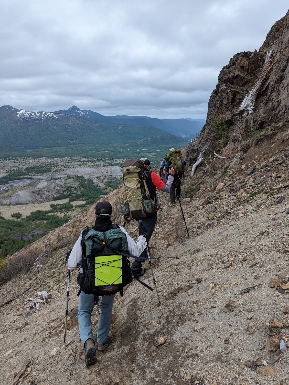 Volunteers hike to the Johnston Ridge Observatory on May 24 to retrieve equipment after a landslide earlier this month cut off access to the site.