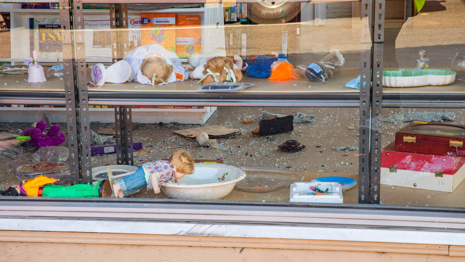 Glass is seen shattered at Visiting Nurses in Centralia after a vehicle crashed through windows, destroying shelves full of items, at the location Thursday morning.
