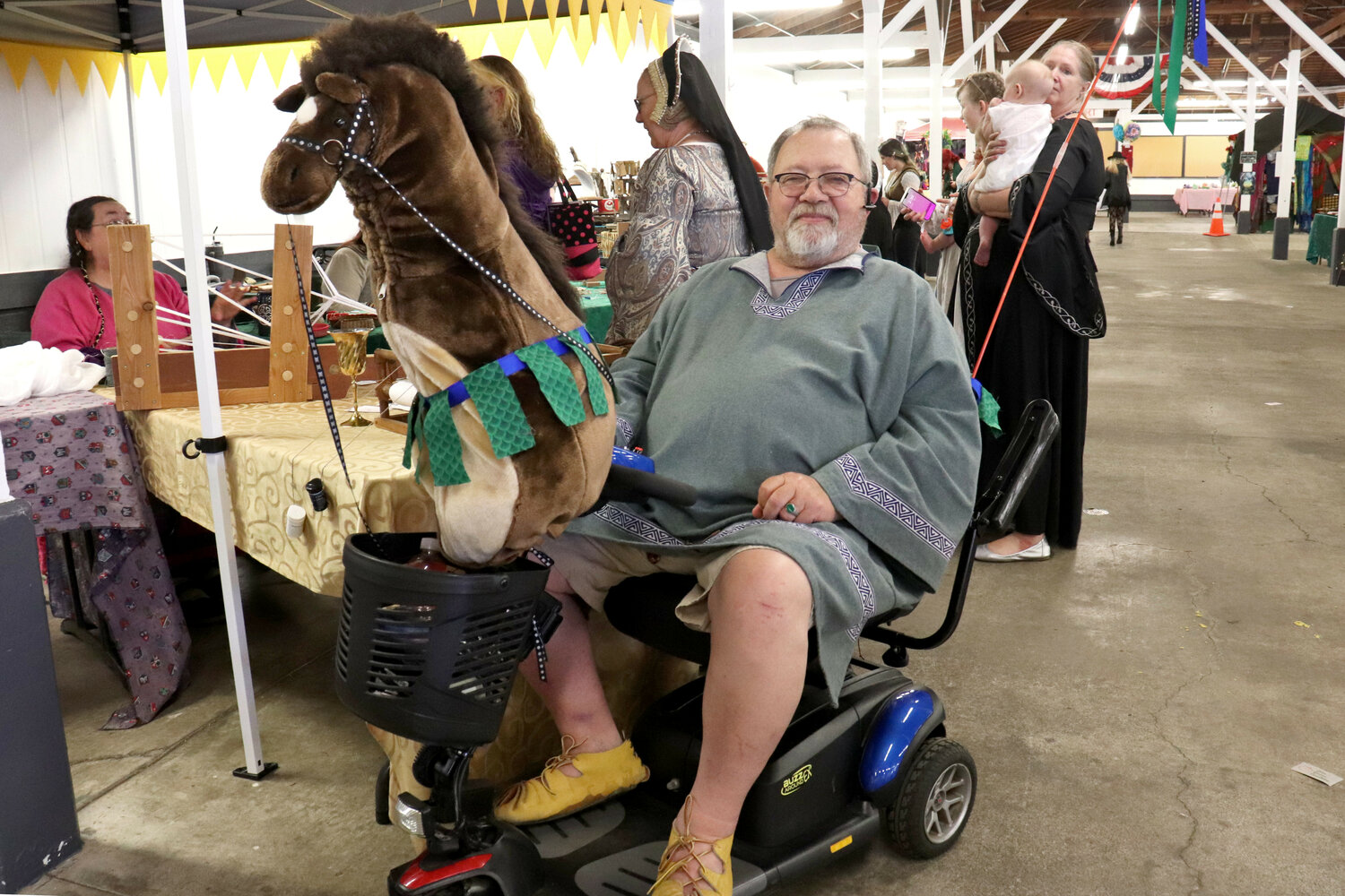 Live-action roleplayer “Tedious The Wood Butcher” rides his steed, “Woody the Warhorse,” at the Southwest Washington Fairgrounds in Chehalis during the Centralia Fantasy Festival on Saturday, May 27.