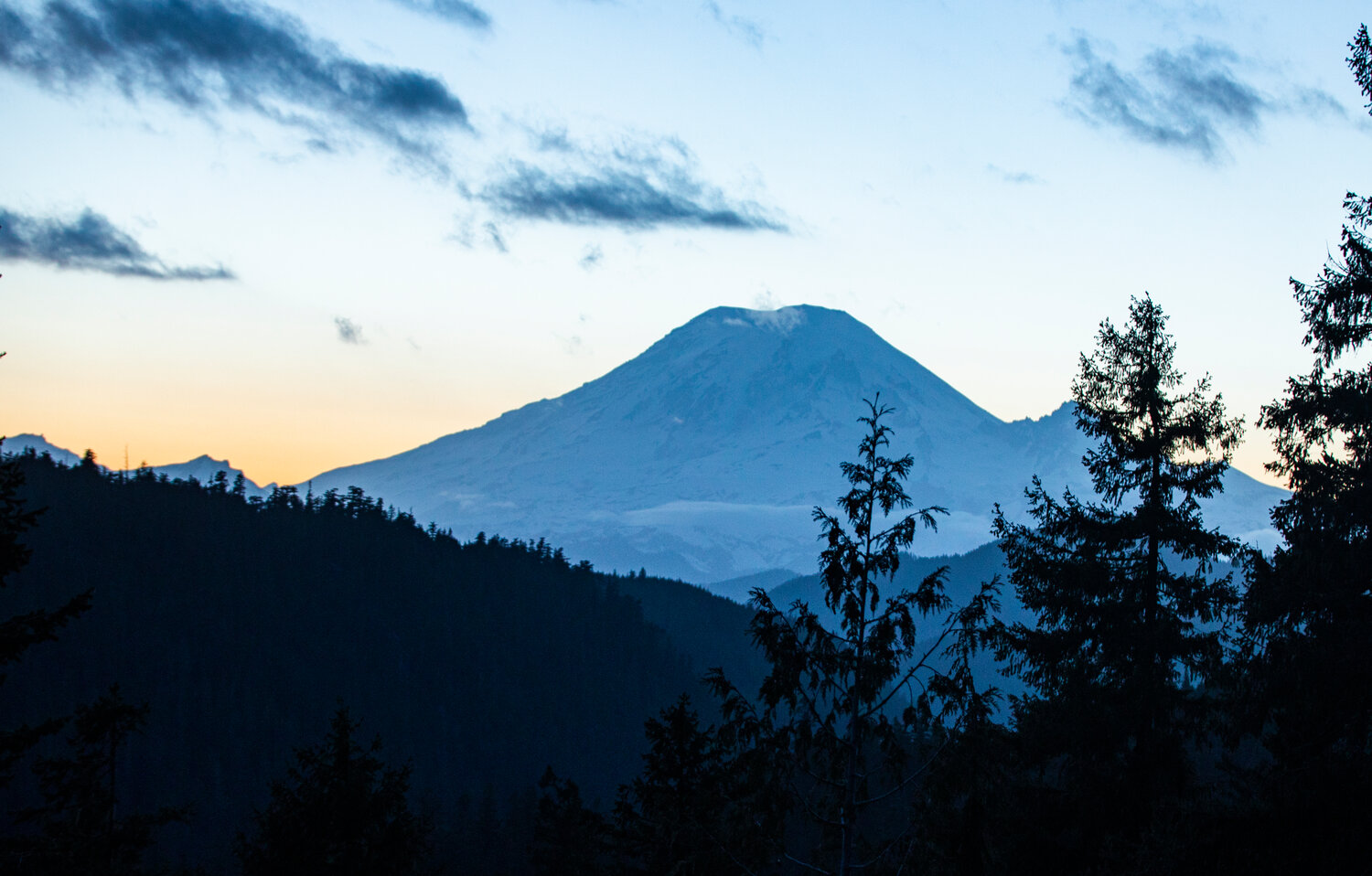 The sun sets behind Mount Rainier as seen from U.S. Highway 12 near White Pass on Saturday.