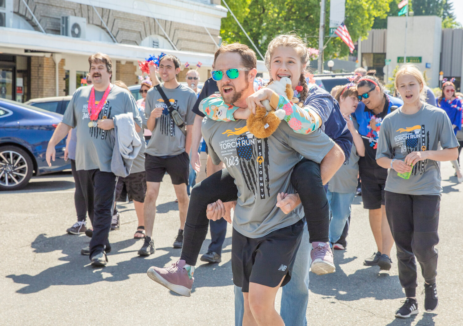 Participants lift each other up and cheer during the Lewis County Special Olympics Law Enforcement Torch Run in downtown Chehalis on Friday, June 2.