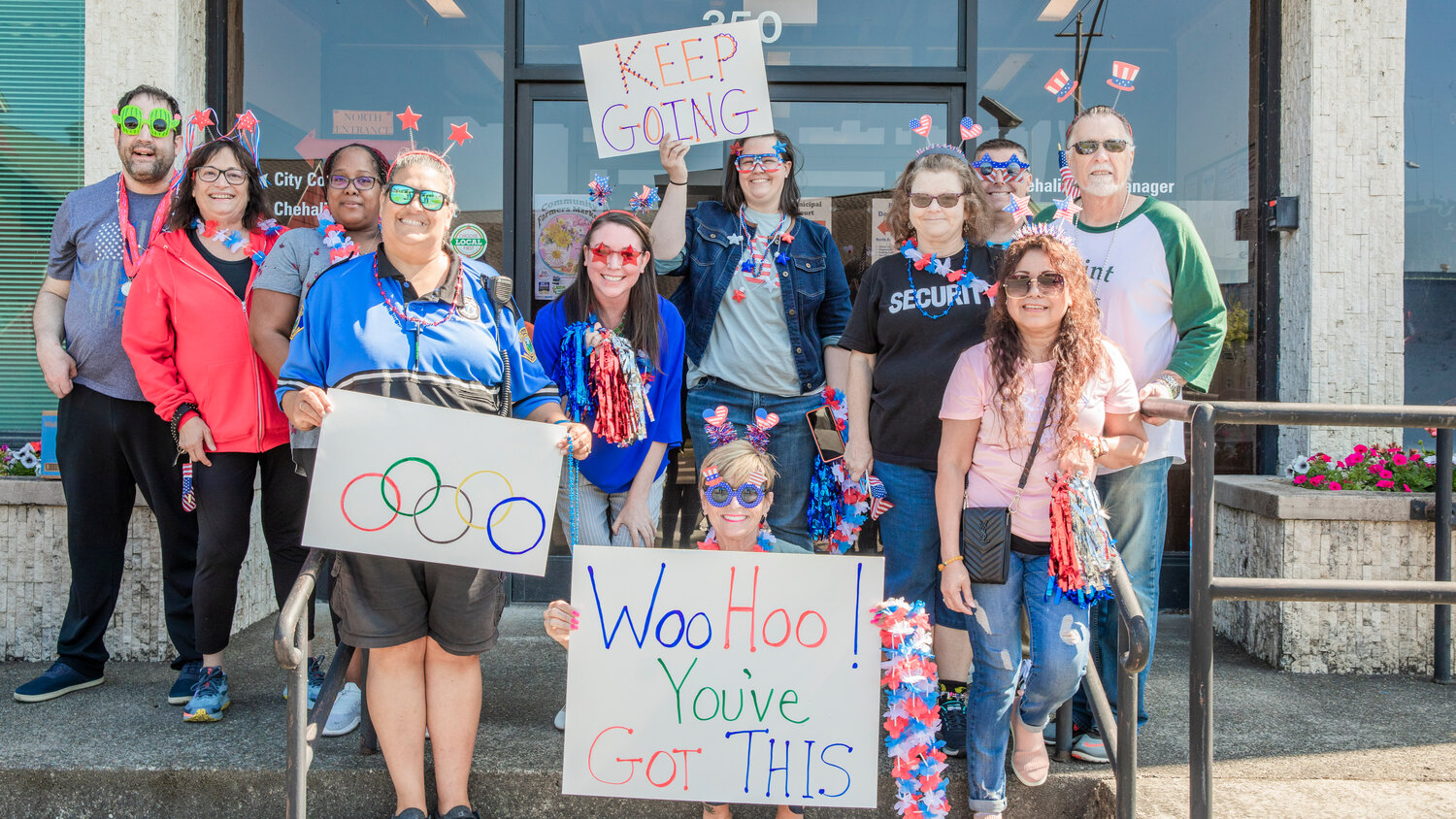 Supporters pose for a photo outside Chehalis City Hall before cheering on participants in the Lewis County Special Olympics Law Enforcement Torch Run on Friday, June 2.