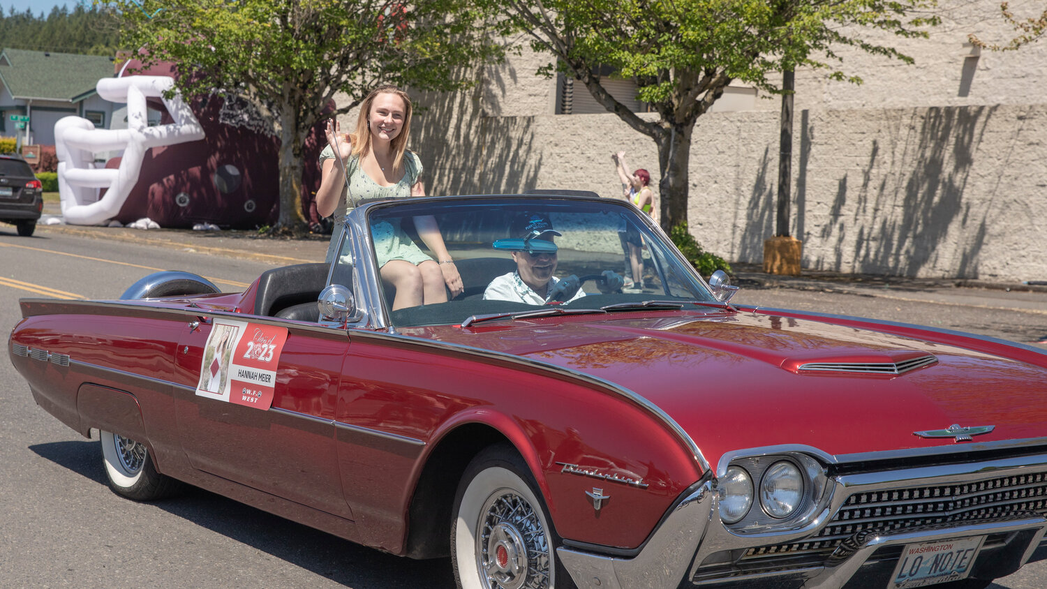 W.F. West High School senior Hannah Meier smiles and waves from a Thunderbird during a parade honoring future graduates in Chehalis on Sunday, June 4.