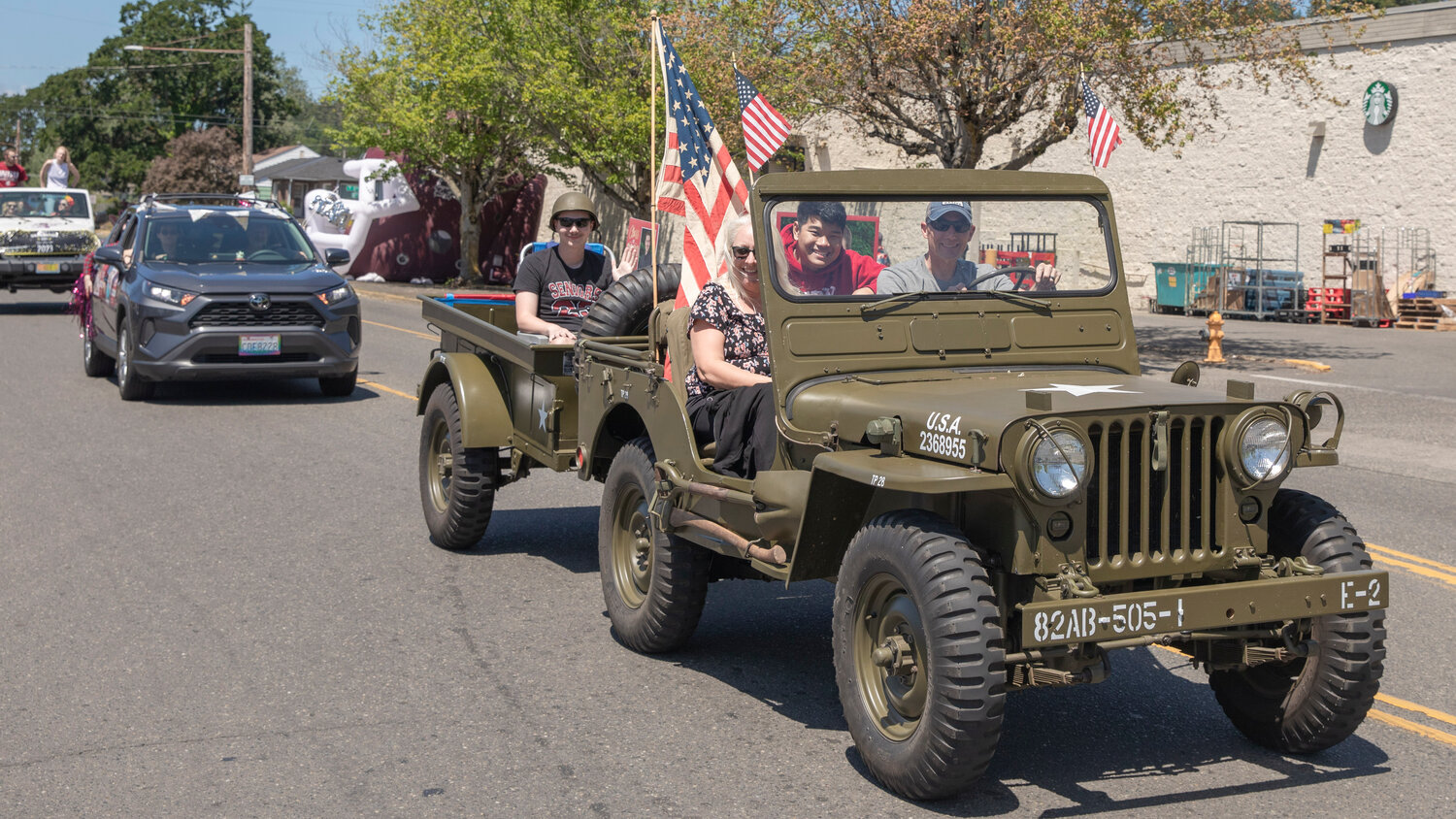 A vintage military Jeep carries W.F. West High School seniors through Chehalis during a parade on Sunday, June 4.