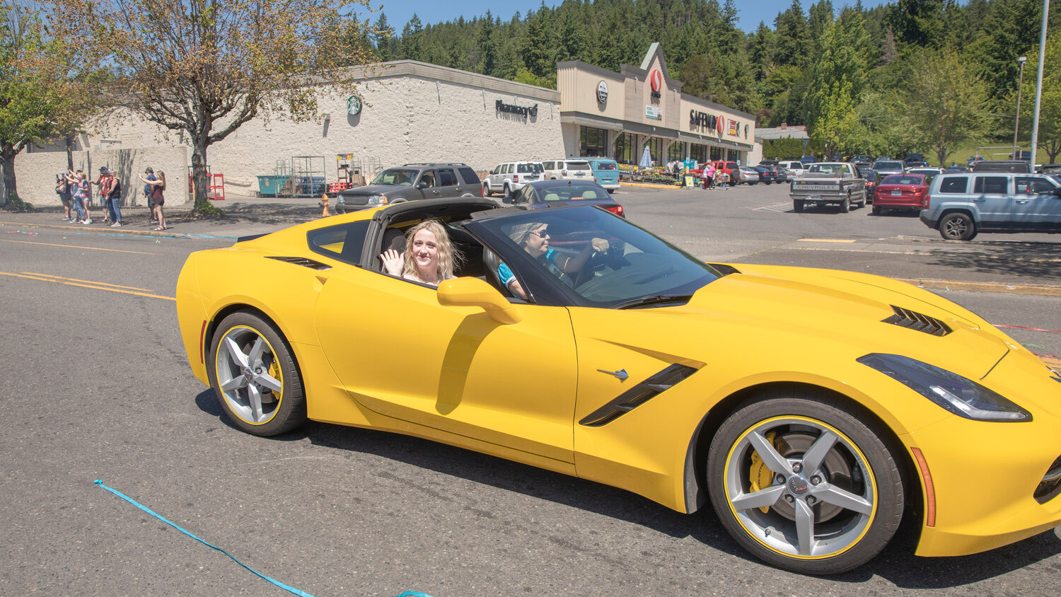 Seniors wave from sports cars during a parade honoring future graduates in Chehalis on Sunday, June 4.