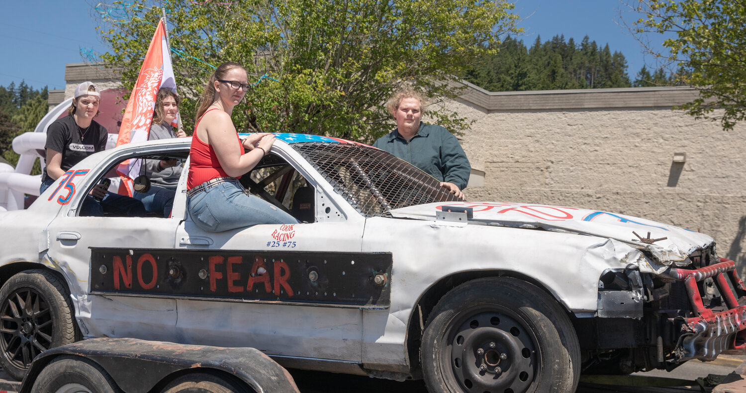 W.F. West High School seniors ride atop a rally car during a parade honoring future graduates in Chehalis on Sunday, June 4.