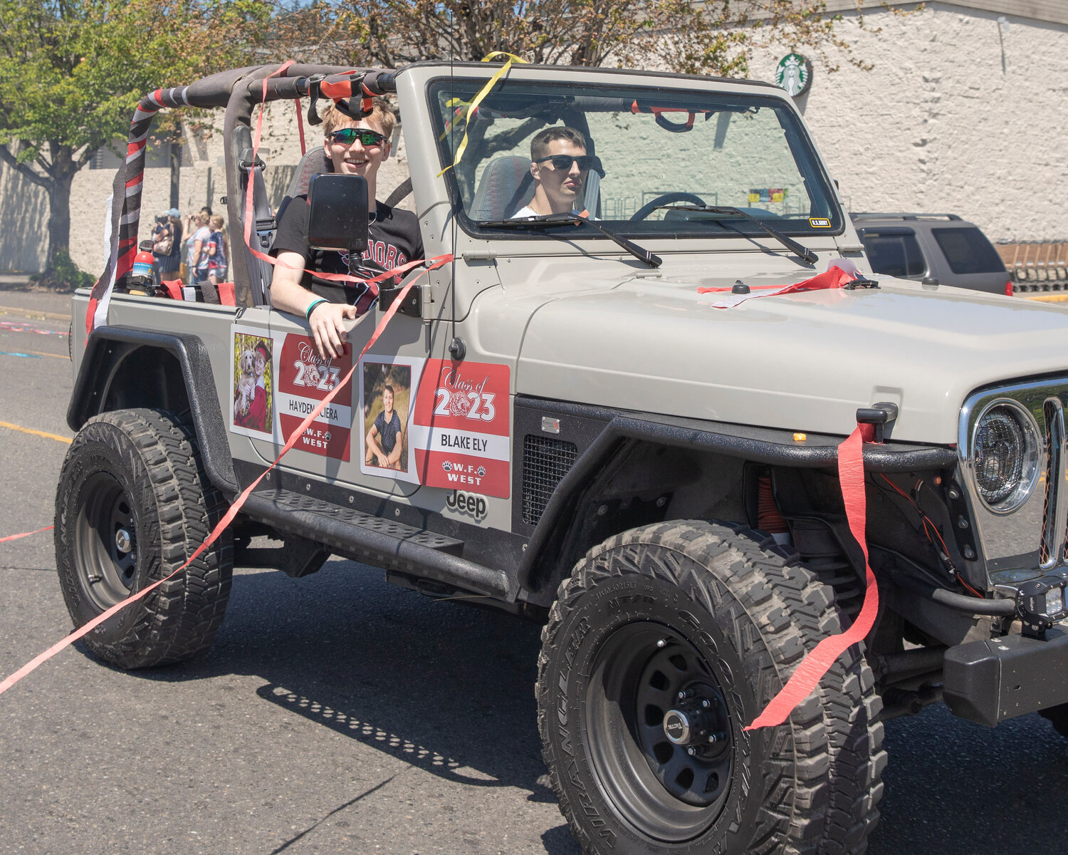 W.F. West High School seniors Hayden Sciera and Blake Ely ride in a Jeep during a parade honoring future graduates in Chehalis on Sunday, June 4.
