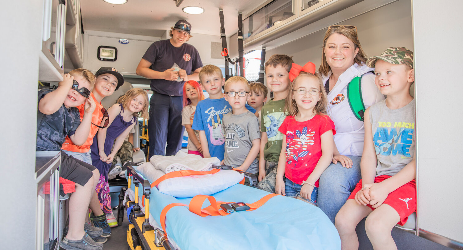 Kindergarten students in Laura Schouten’s class look on from the back of an ambulance during a visit to Lewis County Fire District 5 in Napavine on Tuesday, June 7.