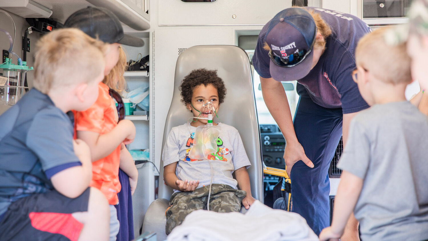 Noah Harrison, 6, tries on the oxygen mask in an ambulance during a visit to Lewis County Fire District 5 in Napavine on Tuesday, June 7.