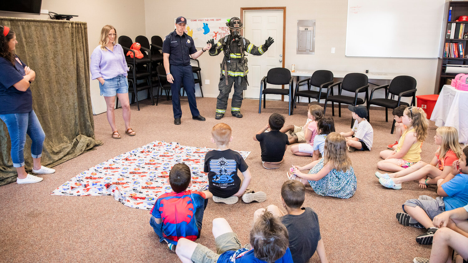 Kindergarten students learn about bunker gear during a visit to Lewis County Fire District 5 in Napavine on Tuesday, June 7.