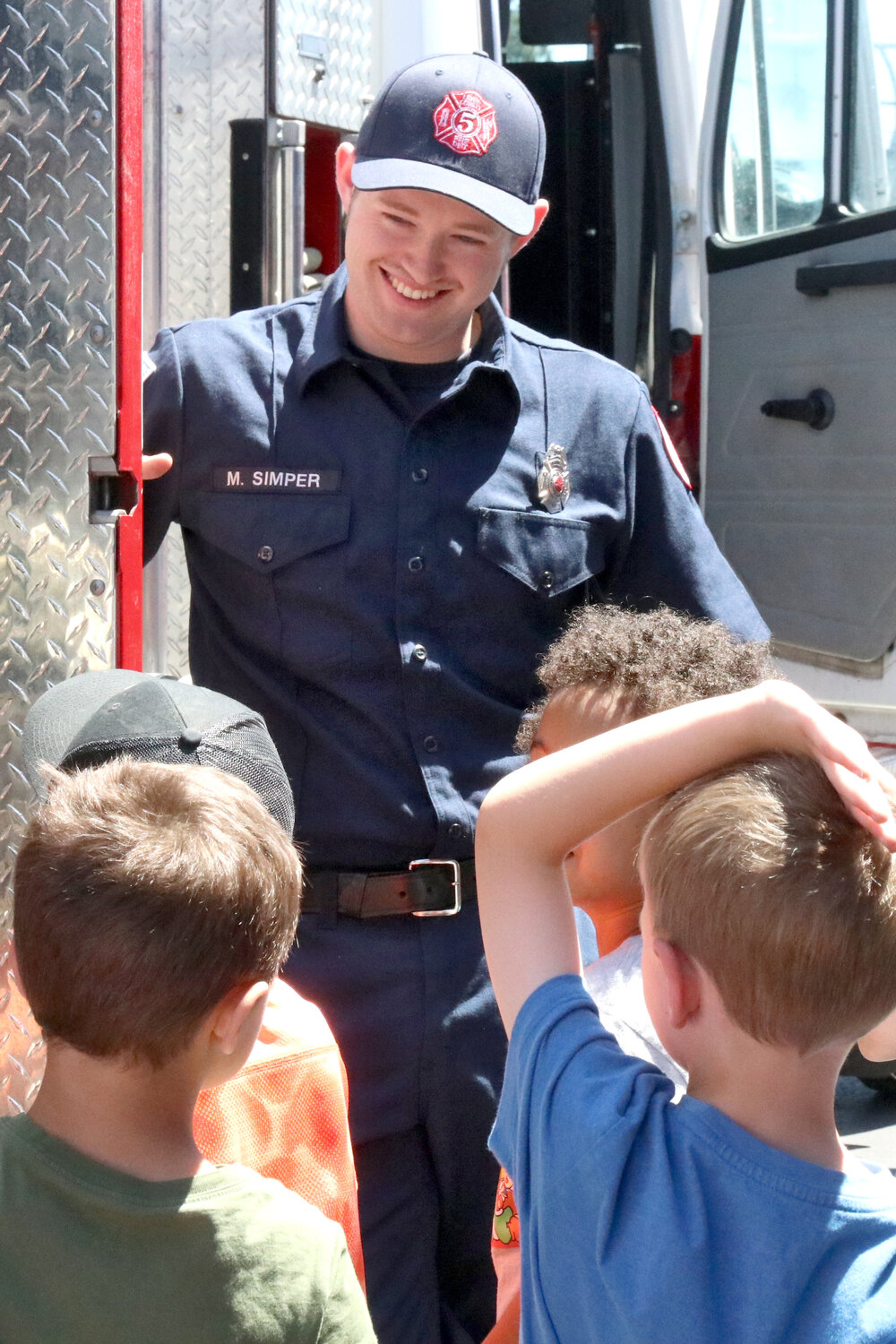 Lewis County District 5 firefighter Malachi Simper gives Napavine Elementary School students a tour of a fire engine outside the fire station in Napavine on Tuesday, June 6.