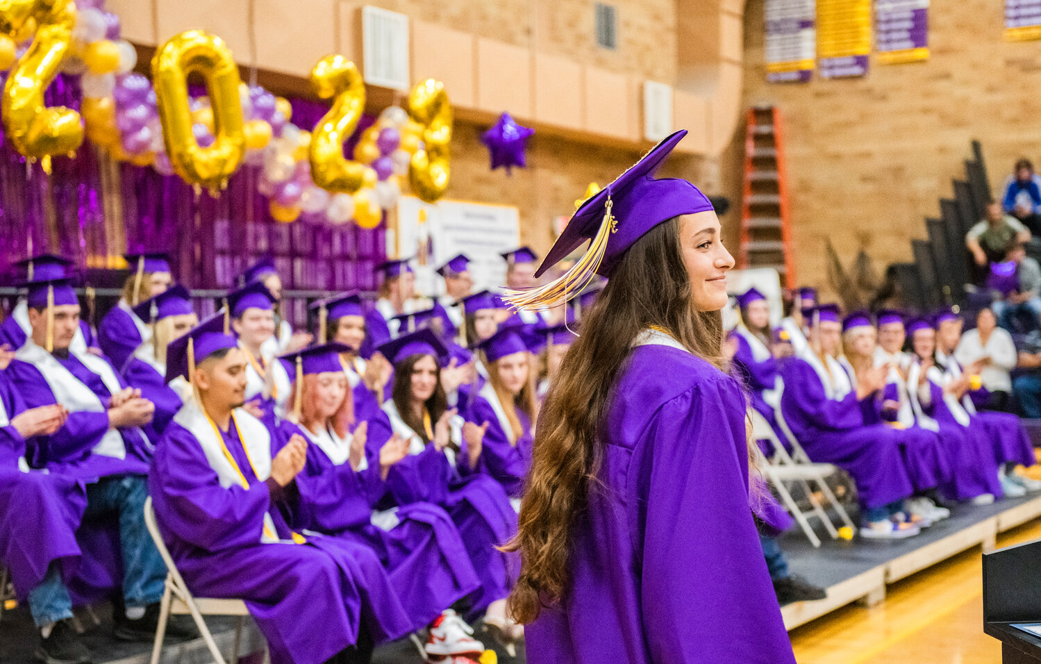 In the Loggers’ gym on Friday night, Onalaska High School’s 100th graduating class of seniors applauds Valedictorian Brooklyn Raya Marie Sandridge, who graduated with the class’ highest honors and will attend Harvard University in the fall as a student and a member of the track team.